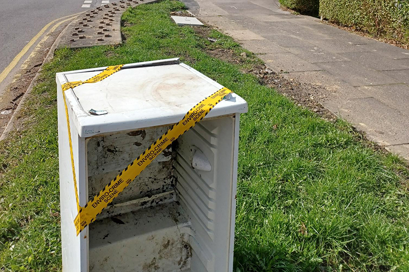 Fridge abandoned on a street corner