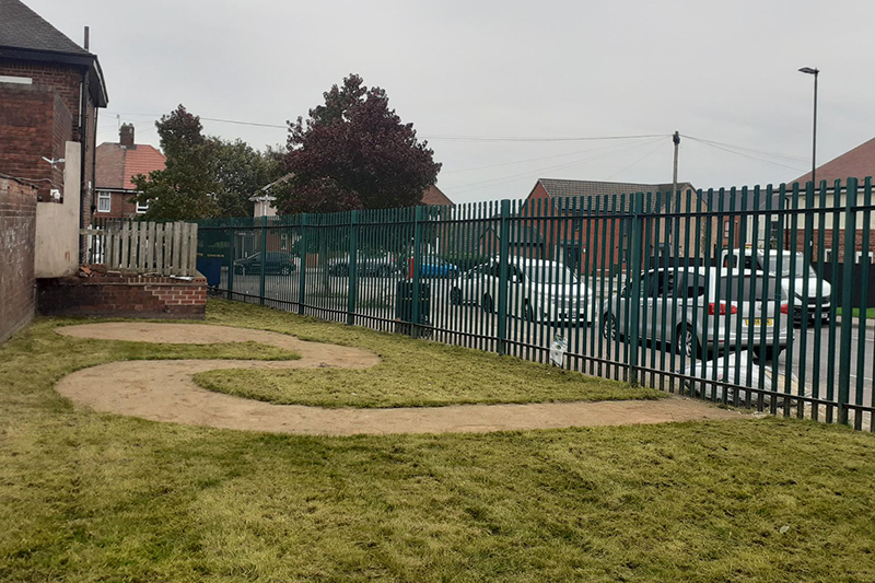Piece of land behind a metal fence