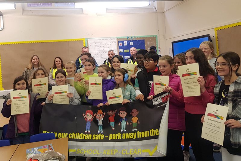 Group of school children holding up signs