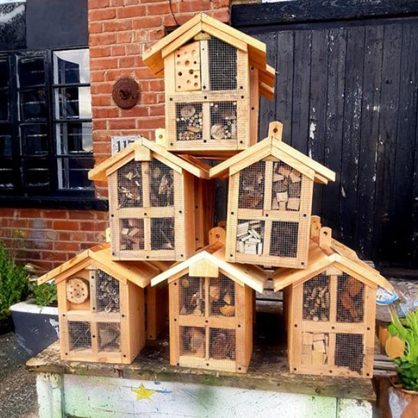 Wooden bug hotels stacked in a pyramid